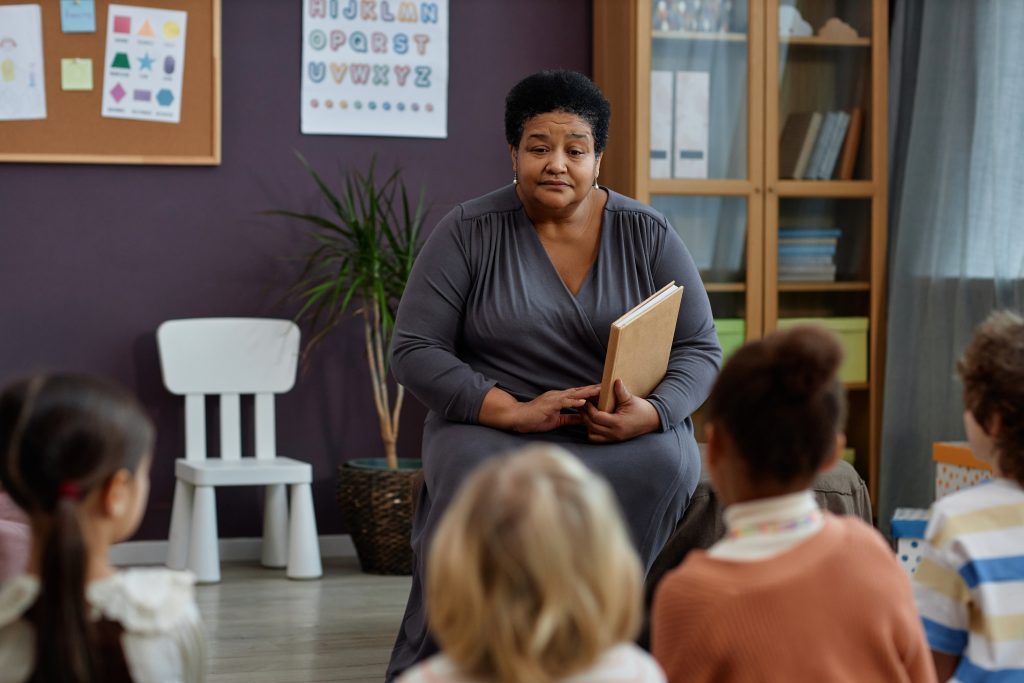 Portrait,Of,Kind,Black,Woman,As,Teacher,Reading,Book,To